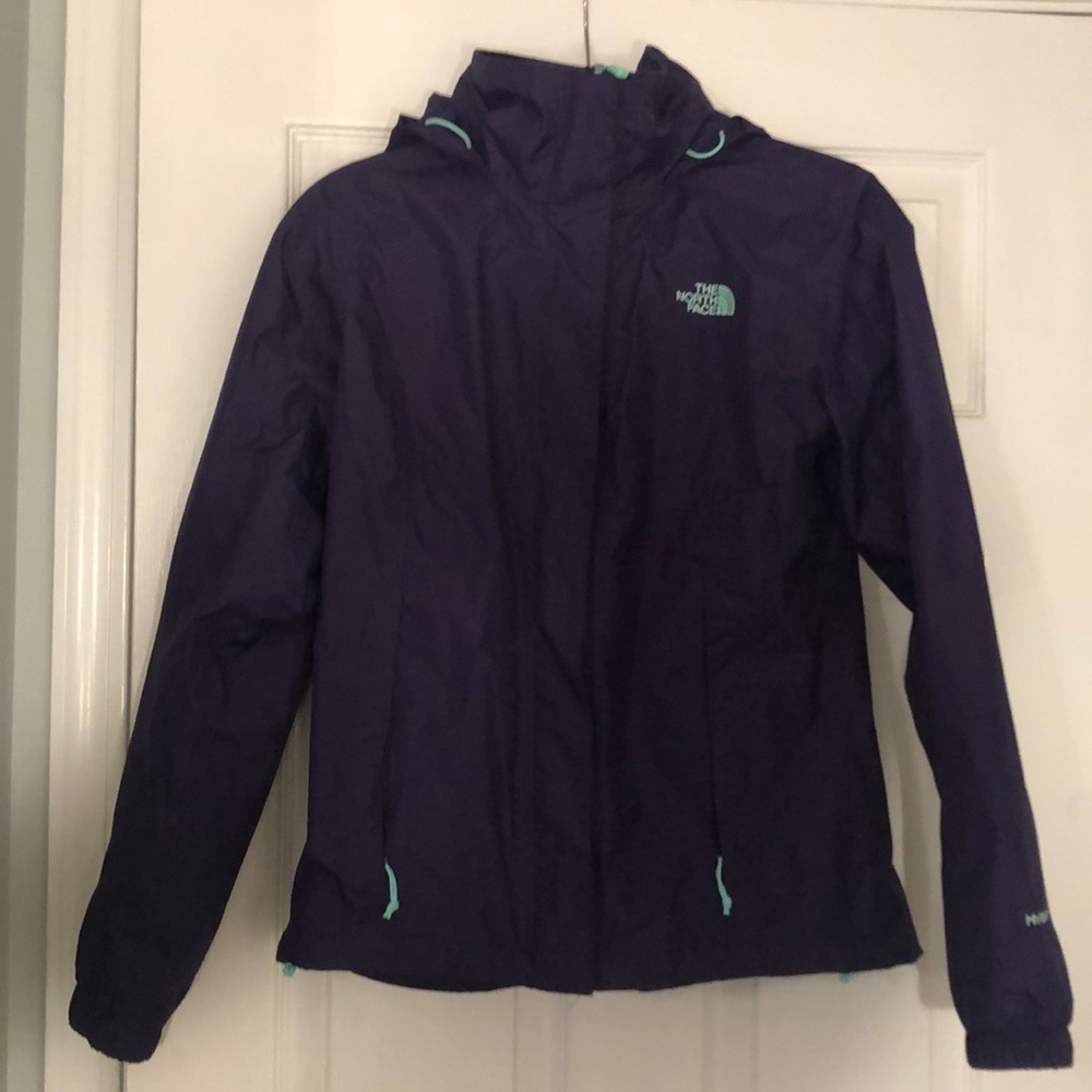 Plum North face rain jacket with teal zippers.